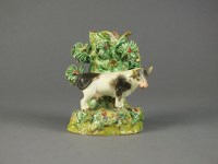 Lot 155 - A Staffordshire spill vase modelled as a cow...