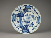 Lot 165 - A large English delft blue and white charger,...