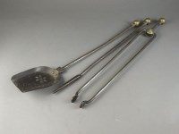 Lot 231 - A steel and brass companion set comprising...