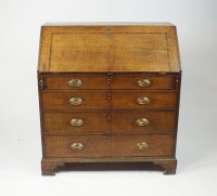 Lot 301 - An oak and walnut crossbanded bureau, first...