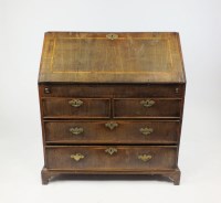 Lot 418 - A crossbanded walnut bureau, 18th century, the...